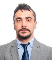 Un hombre en traje posando para fotografia
Descripción generada automáticamente